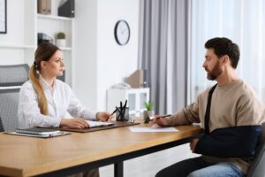 An injured man talks to a lawyer in San Marcos, CA. Learn how a personal injury attorney can seek damages for you after an accident.
