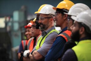A row of construction workers. A San Diego construction accident lawyer can help you following a workplace injury.