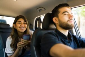 woman riding in back of rideshare car